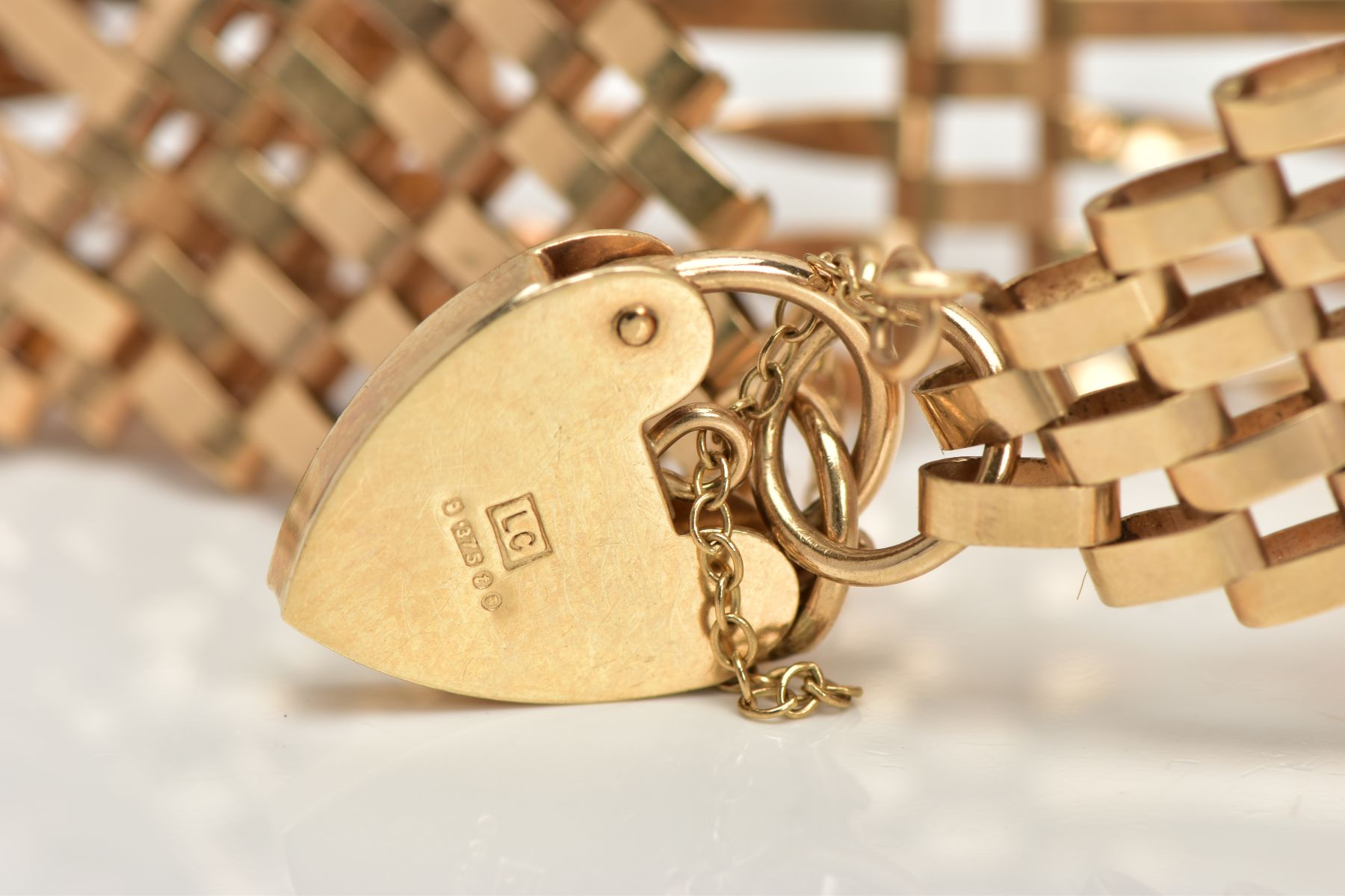 A 9CT GOLD GATE BRACELET, nine row gate bracelet, comprising of six twisted bars and three - Image 2 of 3