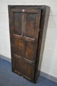 A 17TH CENTURY OAK SINGLE DOOR CUPBOARD, the door with six panels enclosing five shelves, width 74cm