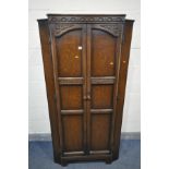 AN OAK TWO DOOR CUPBOARD, enclosing a single shelf, width 93cm x depth 45cm x height 182cm (