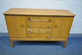 A GORDON RUSSELL OF BROADWAY 1960'S SIDEBOARD, with cupboard doors flanking four drawers, the top