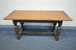 AN OAK REFECTORY TABLE, on four acorn supports, united by a stretcher, length 167cm x depth 73cm x