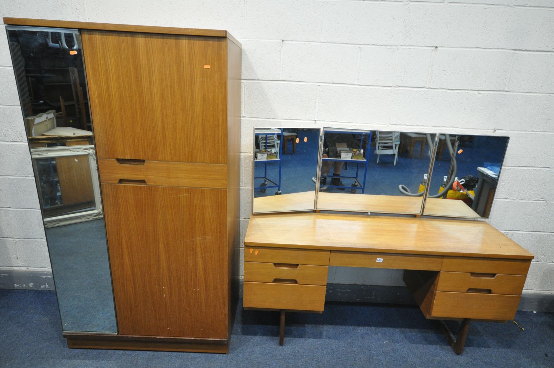 A MID-CENTURY UNIFLEX TEAK TWO PIECE BEDROOM SUITE, comprising a dressing table with a triple mirror