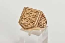 A 9CT GOLD LARGE SIGNET RING, a yellow gold shield shaped signet detailing three lions, leading on