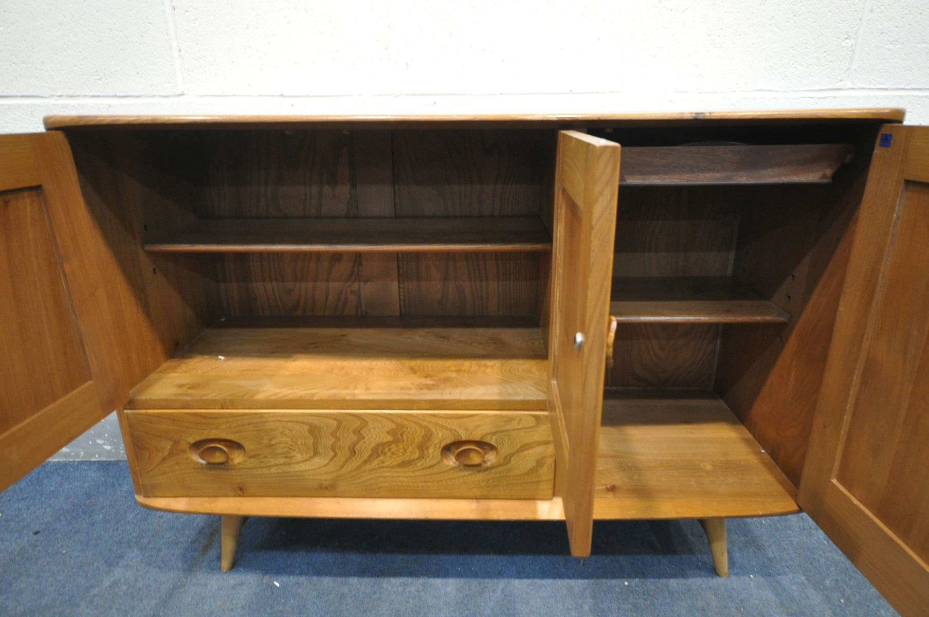 AN ERCOL MODEL 467 ELM AND BEECH SIDEBOARD, with double cupboard door above a single drawer, besides - Image 5 of 6
