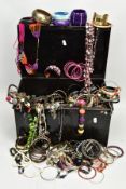 A BLACK TIN FILLED WITH COSTUME JEWELLERY, to include various bangles, beaded necklaces, etc