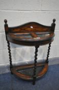 AN EARLY TO MID 20TH CENTURY OAK BARLEY TWIST UMBRELLA STAND, with two divisions, and tin tray,