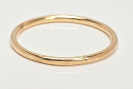 A YELLOW METAL BANGLE, a circular hollow bangle, approximate dimensions width 5mm x inside