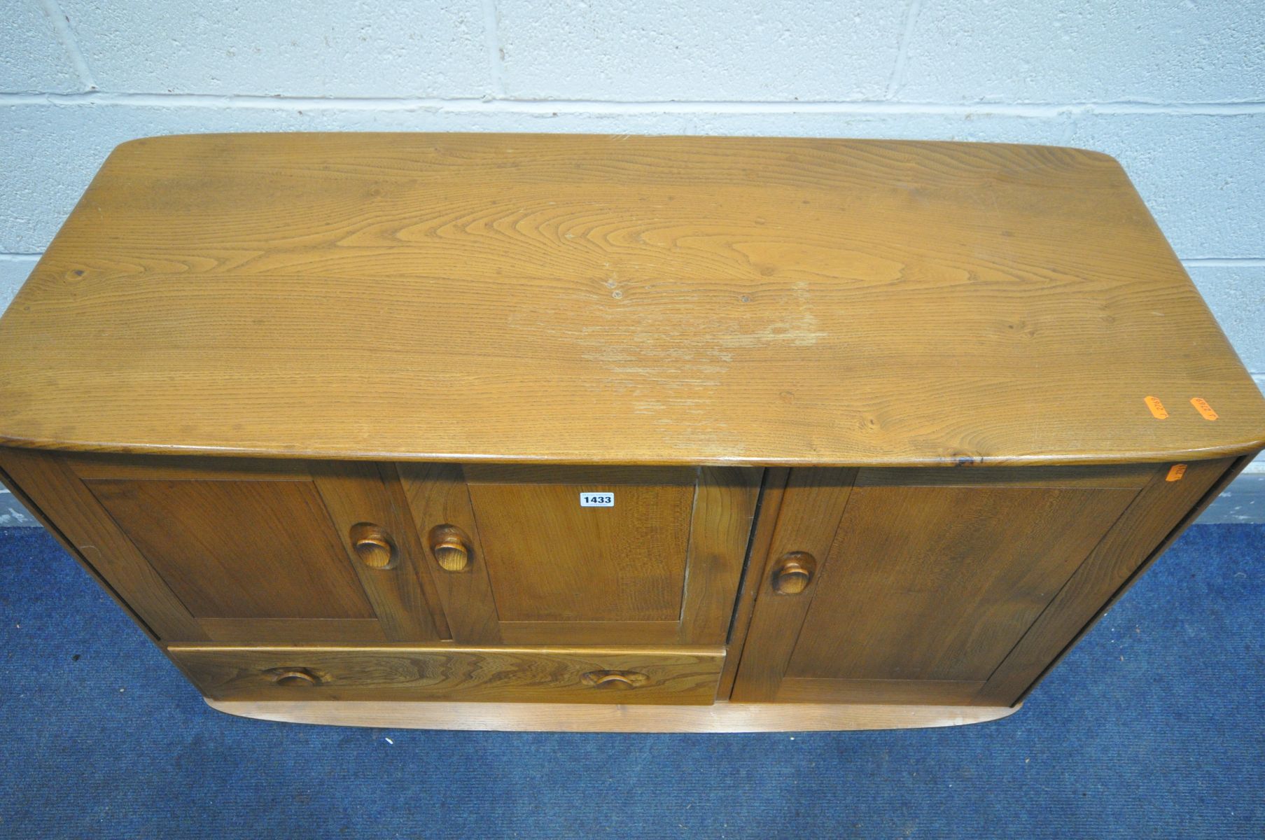 AN ERCOL MODEL 467 ELM AND BEECH SIDEBOARD, with double cupboard door above a single drawer, besides - Image 2 of 6