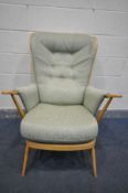 AN ERCOL BLODE ELM WINDSOR ARMCHAIR, with green upholstery (condition:-cushion worn in places)
