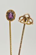 TWO YELLOW METAL STICK PINS, the first detailed with an oval cluster, centring on an oval cut