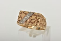 A 9CT GOLD DIAMOND SIGNET RING, a yellow gold rectangular signet ring, textured detail with a