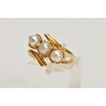 A YELLOW METAL CULTURED PEARL THREE STONE RING, of openwork design, comprising two split and one