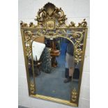A LARGE RECTANGULAR GILT WOOD FRENCH WALL MIRROR, with carved foliate surmount and decoration, width