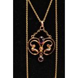 A YELLOW METAL LAVALIER PENDANT NECKLACE, openwork scroll pendant set with an oval cut amethyst in a
