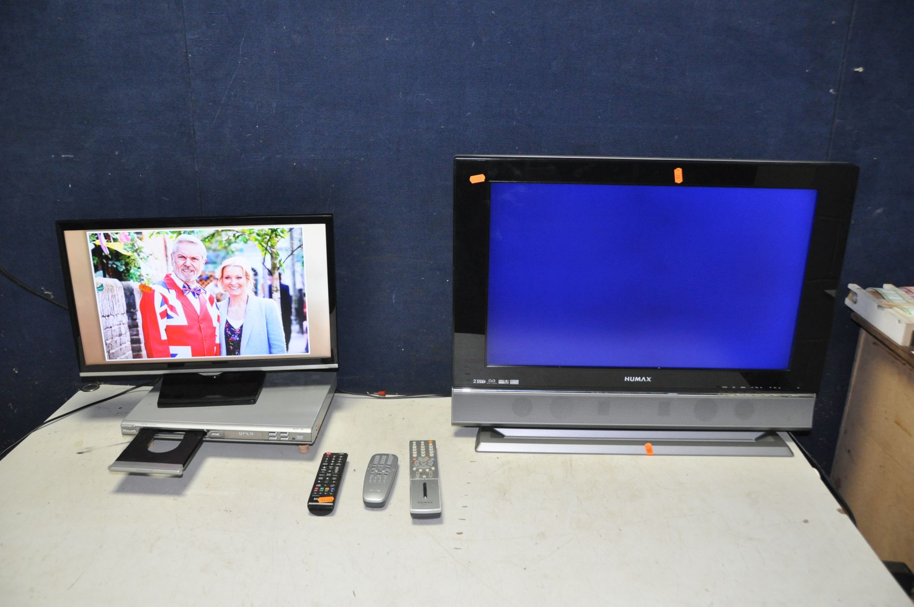 A SAMSUNG T22E310EX 22in tv with remote, a Humax LGB-26DTT 26in tv with remote and a Philips DVP3005