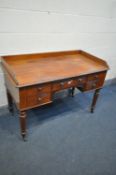A VICTORIAN MAHOGANY DESK, with a gallery back and sides, five assorted drawers, on turned legs