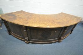 A GOOD QUALITY 20TH CENTURY OAK AND POLLARD OAK CURVED PEDESTAL DESK, the top with book matched