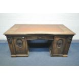 A FRENCH OAK KNEE HOLE DESK, with a leatherette writing surface, single drawer flanked by two