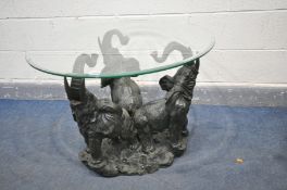 A CIRCULAR BEVELLED GLASS COFFEE TABLE, the base forming three bellowing elephants, diameter 80cm