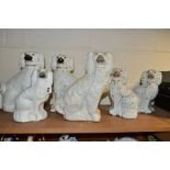 SIX STAFFORDSHIRE SPANIELS, white glazed with gilt details, comprising two pairs approximate heights