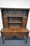 A EARLY TO MID 20TH CENTURY OAK DRESSER, the top with two cupboard doors, the base with three deep