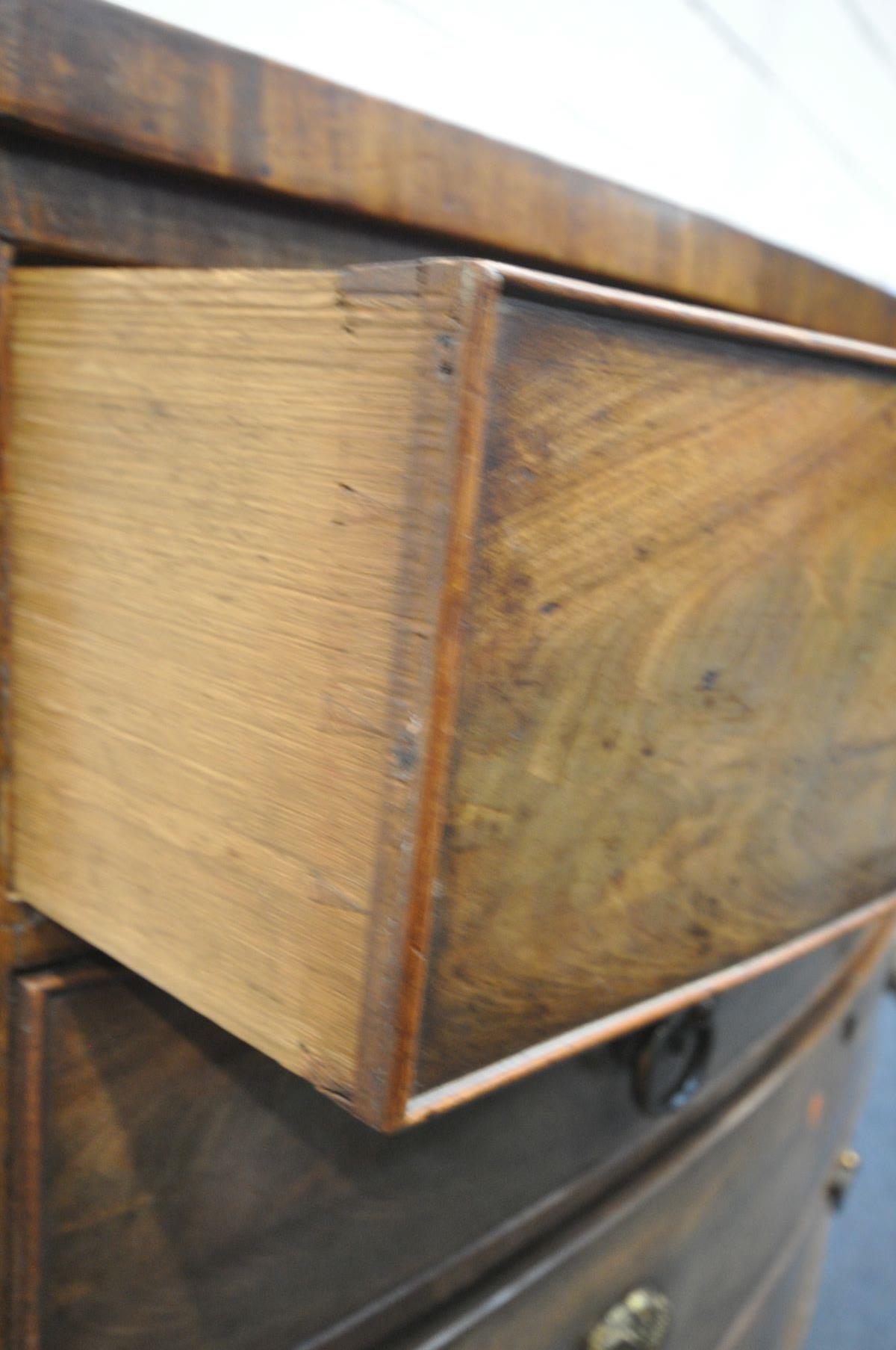 A GEORGIAN FLAME MAHOGANY BOWFRONT CHEST OF TWO SHORT AND THREE LONG DRAWERS, with brass circular - Image 5 of 5