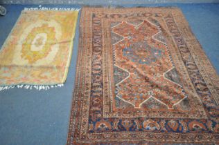 A 19TH CENTURY MIDDLE EASTERN HAND WOVEN RED HERIZ RUG, 160cm x 210cm, and a gold foliate rug (2)