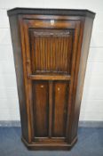 A 20TH CENTURY SOLID OAK LINENFOLD SINGLE DOOR HALL ROBE, width 95cm x depth 47cm x height 190cm (