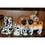 NINE STAFFORDSHIRE/STAFFORDSHIRE STYLE DOGS, to include a pair of porcelain, probably German,
