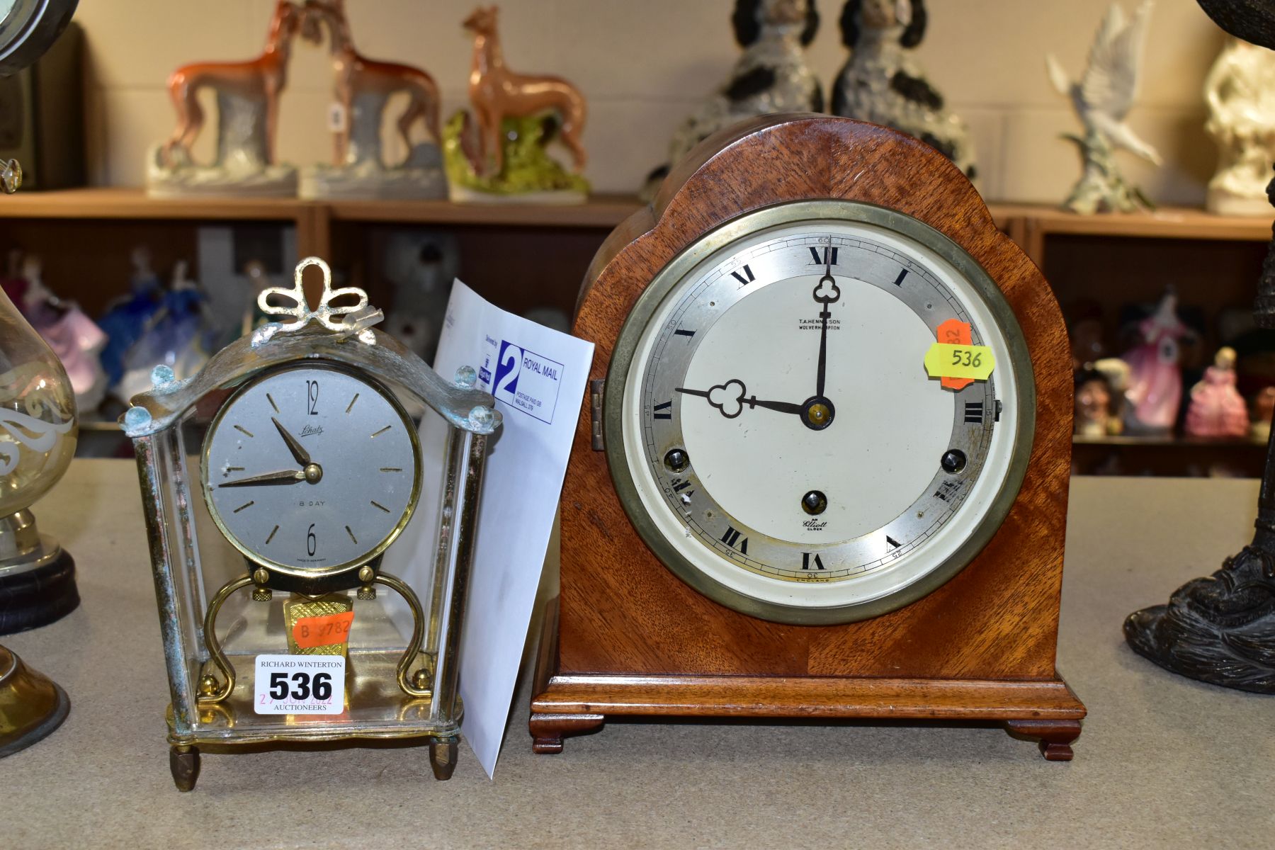 A MID 20TH CENTURY WALNUT ARCH CASED ELLIOT MANTEL CLOCK, silvered chapter ring with Roman numerals,