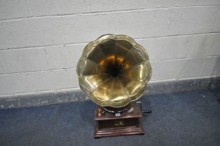 A HIS MASTERS VOICE GRAMOPHONE, with a brass horn, square base, winding handle and spare needles (