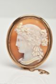 A YELLOW METAL CAMEO BROOCH, of an oval form, depicting a lady in profile, collet mount with a plain