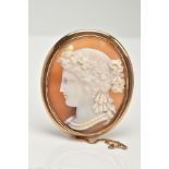 A YELLOW METAL CAMEO BROOCH, of an oval form, depicting a lady in profile, collet mount with a plain