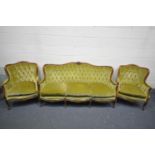 A MID TO LATE 20TH CENTURY FRENCH STYLE THREE PIECE SUITE, covered in green buttoned upholstery,