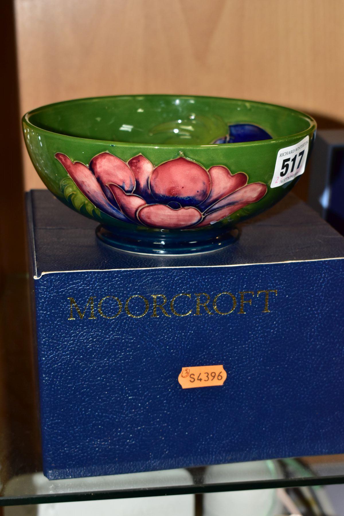 A BOXED MOORCROFT ANENOME BOWL, with tubelined pink and purple anemones on a green/blue ground,