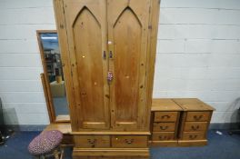 A PINE BEDROOM SUITE, comprising a large double door wardrobe, with two drawers, width 119cm x depth