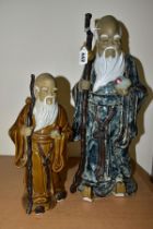 TWO CHINESE CERAMIC FIGURES, each holding a stick and a fruit, late twentieth century/