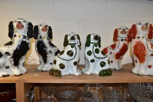 THREE PAIRS OF STAFFORDSHIRE SPANIELS, comprising a pair with copper lustre details (lustre worn)