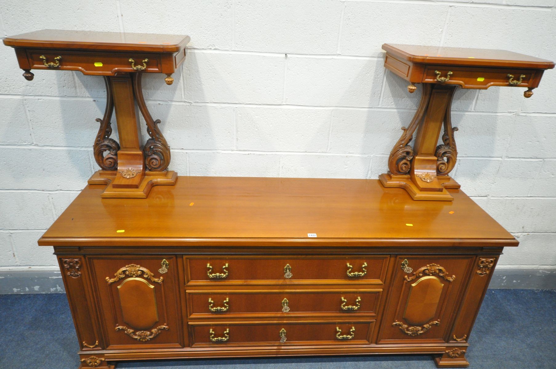 A MAHOGANY SIDEBOARD, two cupboard doors with foliate and panelled cupboard doors, flanking three