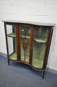 AN EDWARDIAN MAHOGANY AND MARQUETRY INLAID DISPLAY CABINET, with double bowfront cupboard doors,