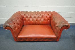 A RED LEATHER CHESTERFIELD SOFA, length 158cm (condition:-some buttons loose/missing, worn and