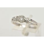 A 9CT WHITE GOLD DIAMOND RING, centring on an illusion set round brilliant cut diamond, flanked with