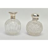 TWO GLASS SILVER TOPPED PRESSED BOTTLES, each designed as a rounded glass bottle with silver tops