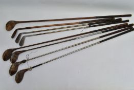 EIGHT VINTAGE GOLF CLUBS, comprising a wooden shaft driver and wedge and steel shaft clubs