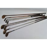 EIGHT VINTAGE GOLF CLUBS, comprising a wooden shaft driver and wedge and steel shaft clubs