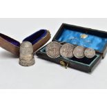 A CASED EARLY 20TH CENTURY SILVER THIMBLE AND A CASED MAUNDY COIN BROOCH, the first with scroll