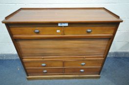 A CHERRYWOOD CABINET, with arrangement of drawers, and a central tambour door enclosing three