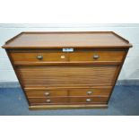 A CHERRYWOOD CABINET, with arrangement of drawers, and a central tambour door enclosing three