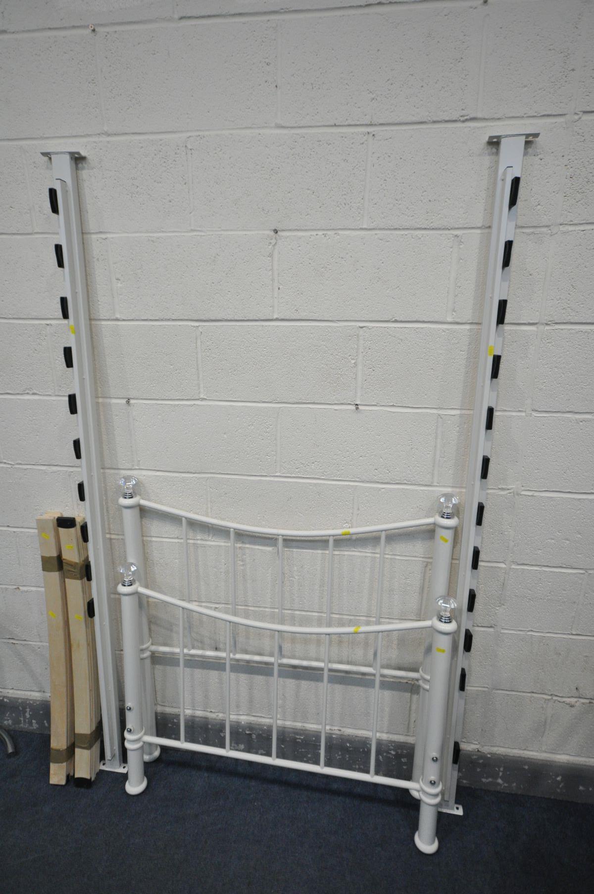 A MODERN WHITE PAINTED METAL BEDSTEAD with side rails, slats and bolts