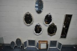 A LARGE QUANTITY OF MIRRORS, comprising a pair of white painted oval French style wall mirrors, a